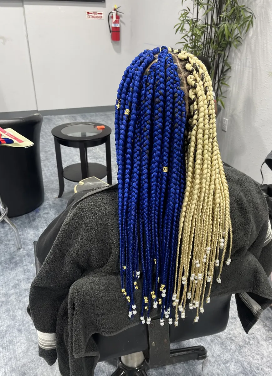 Box braids split blue and blonde, finished with beads